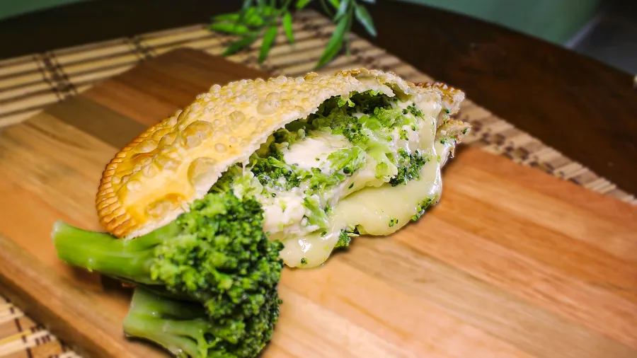 Pastel Vegetariano aberto, mostrando o recheio, servido na Pastello